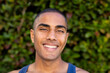 © Wavebreak Media - Portrait of happy biracial man with buzz cut hair smiling in sunny garden