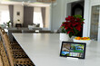 © Wavebreak Media - Tablet with a home security camera views on screen in kitchen