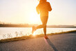 © Andrii IURLOV - Woman running outdoors. Healthy lifestyle concept, people go in sports. Silhouette family at sunset. Health care, authenticity, sense of balance and calmness.