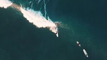 Woman Surfs The Wave On Batu Bolong Surfing Spot In Bali, Indonesia. Aerial Top Down View Of The Female Surfer Riding The Wave