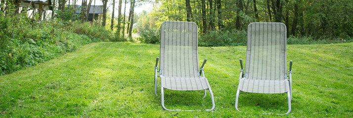 two sun loungers on the lawn in the garden