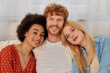 modern family, polygamy concept, freedom in relationship, cultural diversity, portrait of redhead man and multicultural women looking at camera, polyamorous lifestyle, non traditional lovers
