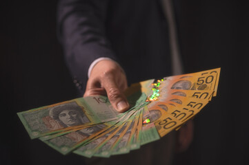 Wall Mural - investment and financial saving concept, Money, Australian dollar (AUD) banknotes, in businessman hands, trading property invest stock market investors