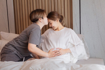 happy asian lgbtq+ couple kissing forehead of pregnant woman, mature lesbian girls decide to vitro f