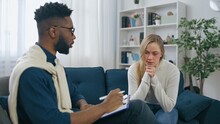 African American Psychiatrist Talking With Young Scared Woman Domestic Violence Victim