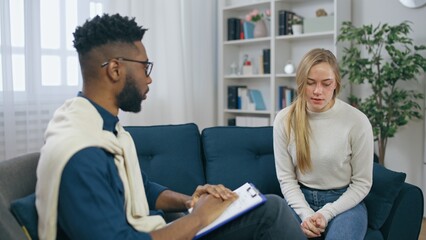 African American male psychiatrist talking with domestic violence victim, emotional support