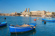Small Blue Boats Moored In The Water Of The Harbour Of The Old Medieval Town Of Barletta, Adriatic Sea Sea, Apulia