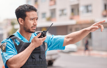 Poster - Asian man, police and pointing with walkie talkie in city for emergency dispatch, arrest or calling suspect. Male person, cop or law enforcement with radio signal for communication or safety in town