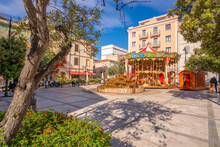 View Of Carousel And Fountain On Piazza Matteotti On Sunny Day In Olbia, Olbia, Sardinia