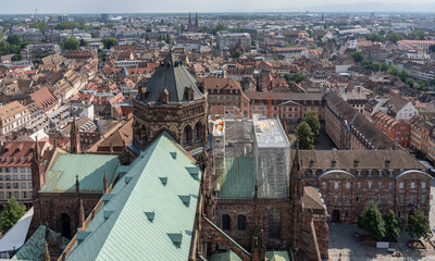 Wall Mural - Strasbourg, France - 06 26 2023: Strasbourg cathedral: View of the roof of the cathedral and the city around from the top.