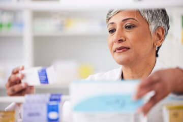 Canvas Print - Pharmacist, shelf and a woman with a medicine box in a pharmacy for inventory or prescription. Mature female employee in healthcare, pharmaceutical and medical industry reading product information