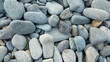 © Arda ALTAY - close up view of pebbles on the beach. Abstract nature pebble background. Small sea stones on the beach, vacation at sea. top view. Zen balance, minimalism, harmony and peace