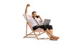 © Ljupco Smokovski - Happy bussinesman on a beach chair using a laptop and a smartphone