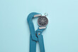 Metal adjustable wrench holding compass on blue background. Business concept