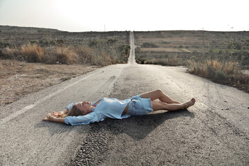 young woman lying on a street