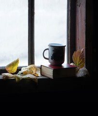 Wall Mural - Coffee mug and book on windowsill