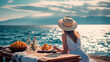 A woman in a straw hat eats food and enjoys the ocean view. Tropical vacation dining table. The concept of travel, holidays, weekends.