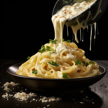 Fettuccine Alfredo With Parmesan Cheese Isolated On Black Background