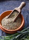 Fototapeta  - Fresh, dried and chopped rosemary put in a ceramic bowl with a bowl