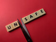 Closeup toys letters with the word UNSAFE