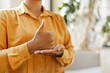 © Maria Vitkovska - Cropped view of the deaf sign language teacher communicating by hands gestures