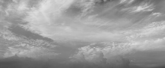 Wall Mural - Grey sky with white clouds in rainy season, beautiful grey and white sky background textures, black and white sky, cloudy sky with stormy clouds. Low cumulus clouds of various shapes cover almost the	