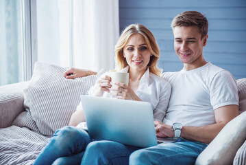 Canvas Print - Beautiful young couple with gadget