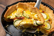 Sun baked tomato, goats cheese and courgette quiche served in cast iron pan
