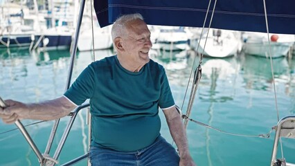 Wall Mural - Senior grey-haired man smiling confident sitting on boat at boat