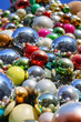 Shiny golden, red, blue, silver and pink Christmas balls as background.
