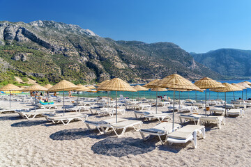 Wall Mural - Beach umbrellas and sun loungers on Oludeniz Beach in Turkey