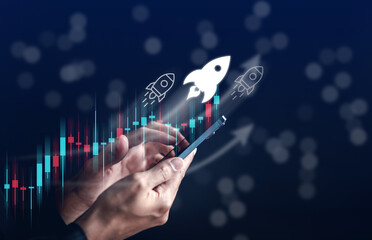 Leinwandbilder - Businessman hold smart phone with rocket launch investment growth, planning and staring corporate business start up aiming objective value development leadership and customer target group.