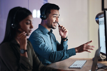 Man, call center and headphones at night in customer service, support or telemarketing at the office. Happy male person, consultant or agent with headset on computer in online advice at the workplace