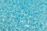Fototapeta Sypialnia - Blue ripped sea water as swimming pool. Crystal clear ocean lagoon bay turquoise blue azure water surface, closeup natural environment. Tropical Mediterranean beach water background