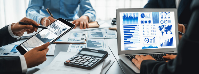 Business intelligence and data analysis concept. Analyst team working on financial data analysis dashboard on laptop screen as marketing indication for effective business strategic planning. Insight