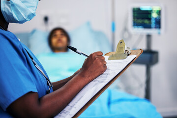 Canvas Print - Hands, healthcare and a nurse writing on documents in a hospital during a patient checkup or report. Medical, insurance and information with a black woman medicine professional in a clinic closeup