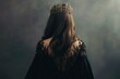 Beautiful queen in gothic style. Beautiful young woman in metal crown and black cloak. Photo from back without face