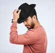 © Sharne T/peopleimages.com - Retro, fashion and portrait of man with a hat for vintage style or hipster clothing trend in white background. Studio, Indian model and serious face with cool, confidence or person acting as a spy