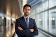 © Yuliia - Corporate portrait Arabian confident Indian businessman posing in office company indoors with hands crossed successful top manager Hispanic American male employer guy business man looking at camera