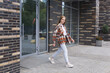 © Evgeny - young woman stepped out of the door of a city building