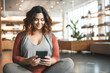 © Nataliia - Authentic Plus Size model, Yoga Influencer, blogger using smartphone to connect with her client base. Generative Ai content