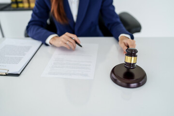 Wall Mural - Lawyer preparing to sign a contract and wooden gavel on table justice and law concept