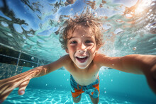 Happy Kid Swimming Underwater And Having Fun. Happy Childhood And Summer Vacation. High Quality Photo