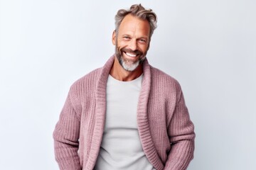 Canvas Print - Cheerful mature man looking at camera and smiling while standing against grey background