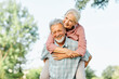 canvas print picture - woman man outdoor senior couple happy lifestyle retirement together smiling love fun elderly active vitality nature mature portrait piggyback game