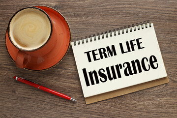 term life insurance open notebook with text near orange mug