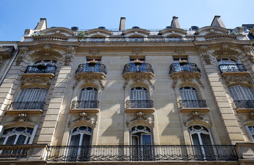 Wall Mural - The facade of traditional French house with typical balconies and windows. Paris.