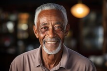 Smiling Senior Black Man Posing Inside A Room Looking At The Camera
