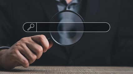 Wall Mural - hand holding magnifying glass. searching for information. using search console with your website. da