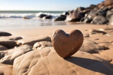 A Heart-shaped Rock On A Sandy Beach